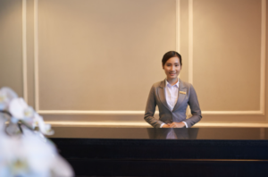 hotel receptionist smiling at you